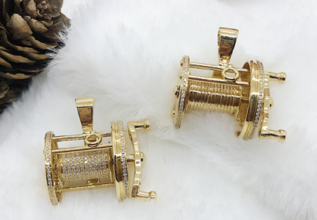 Yellow Gold Fishing Pendants with Diamond along reel on white background with acorn