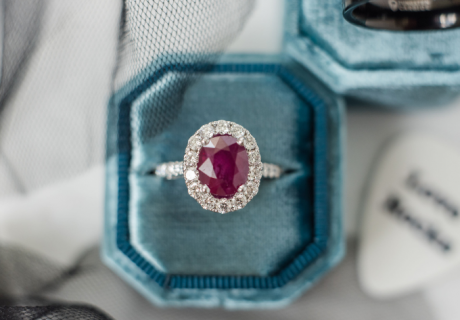 Ruby with halo of diamonds in ring box