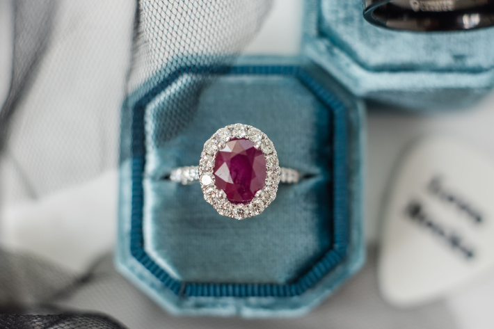 Ruby with halo of diamonds in ring box