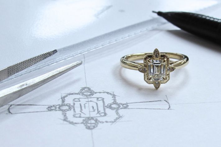 Custom engagement ring drawn out with ring next to it