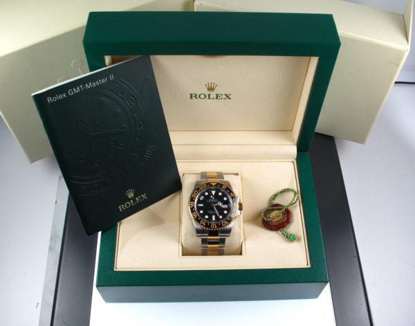2008 Two Tone Pre-Owned Rolex GMT Master II 40MM Watch With Black Index Dial And Black Ceramic Bezel With Oyster Band Model# 116713 Box Papers Inner