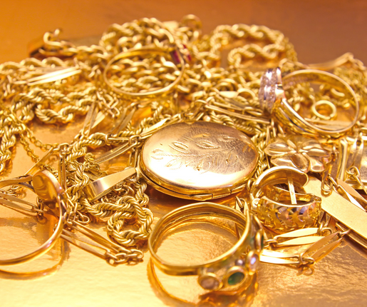 We Buy and Sell Gold. Gold jewelry in big pile.