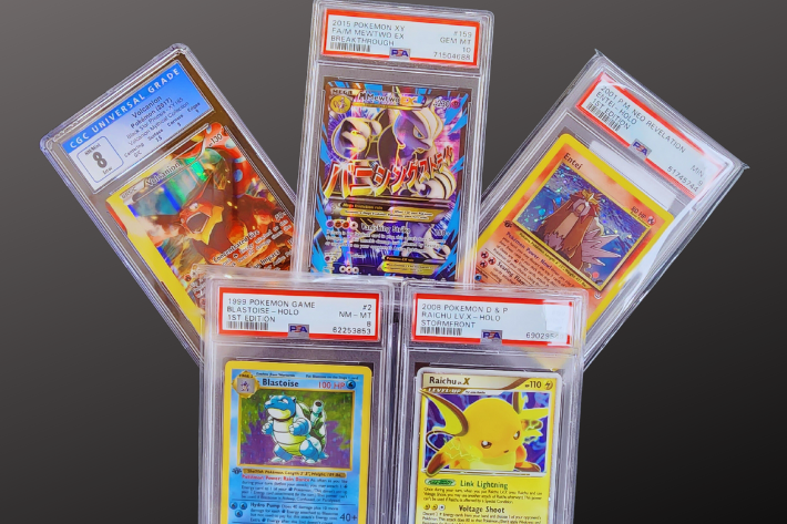 Sell your pokemon Cards for Cash with four graded pokemone cards on black sheet