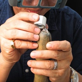 Jeweler inspecting a ring at Arnold Jewelers