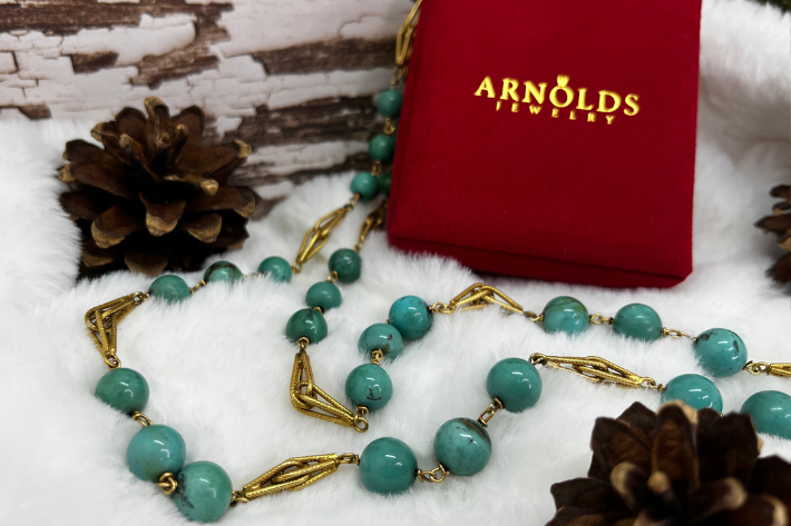 december birthstone turquoise necklace with Arnold Jewelers box in snowy setting