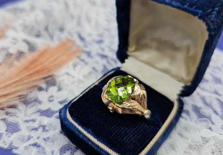 peridot in jewelry ring in antique box