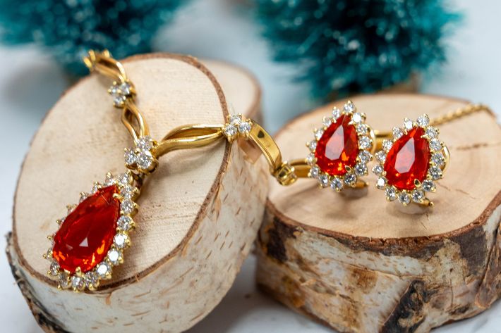 best holiday gifts with gold necklace with fire opal pendant and matching fire opal earrings